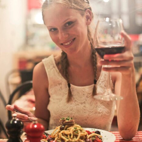 Woman in White Sleeveless Tops Holding Wine Glass